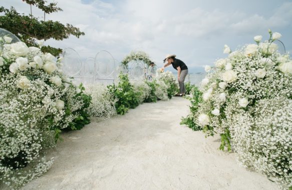 Khim Cruz behind the scenes working beach outdoor wedding ceremony