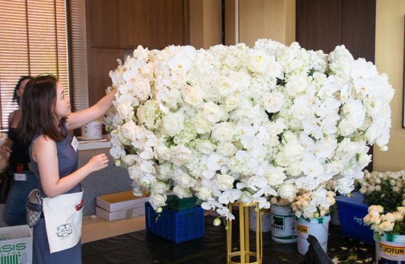 Khim Cruz behind the scenes working on a floral centerpiece