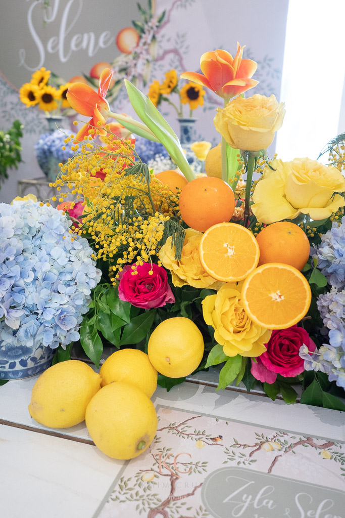 Chinoiserie lemon and orange themed party table flower and fruits centerpieces
