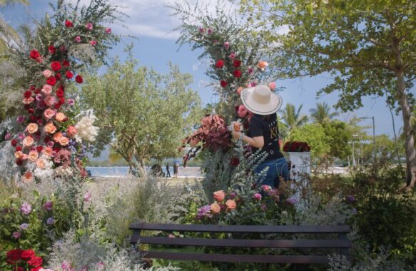 khim cruz florist creating a floral arch for a wedding ceremony