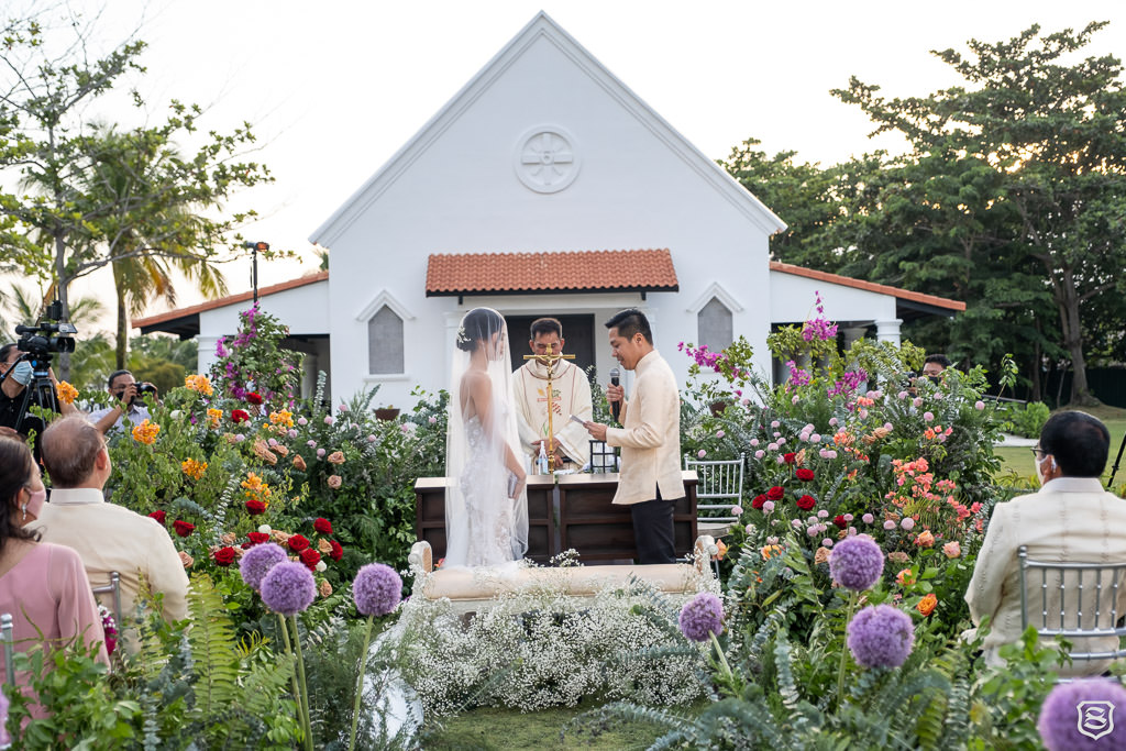 Karlo & Nica with their wedding vows at their outdoor garden theme wedding ceremony designed by Khim Cruz