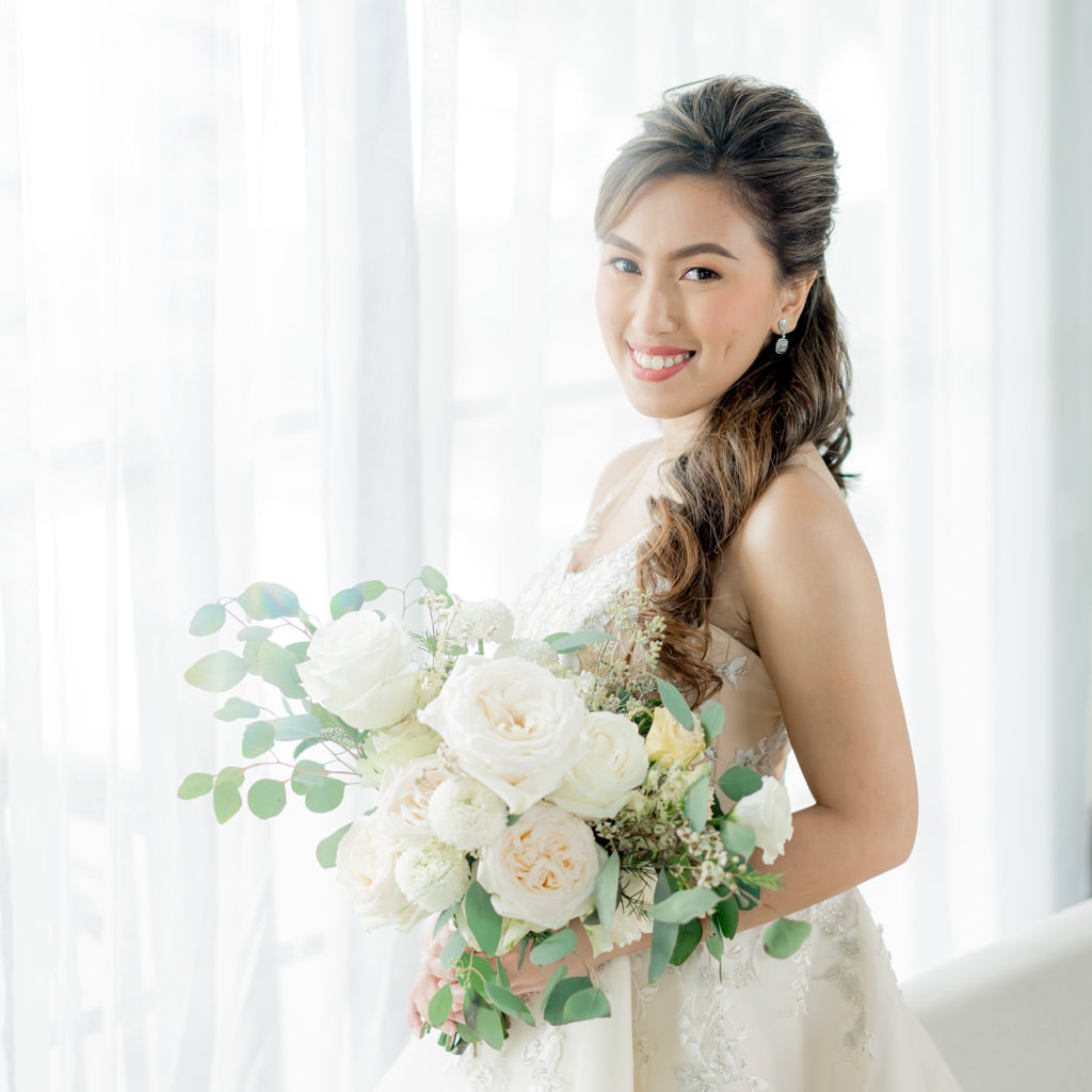 beautiful bride Christine holding her bouquet by Khim Cruz