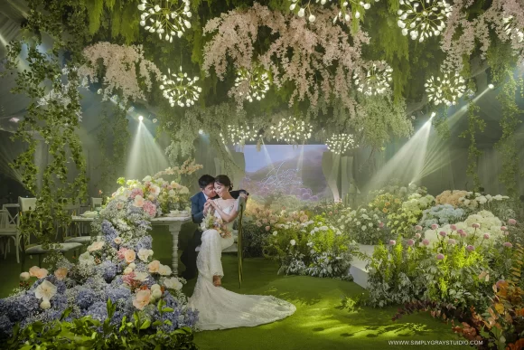 couple on their modern-feel garden themed wedding reception by wedding designer Khim Cruz