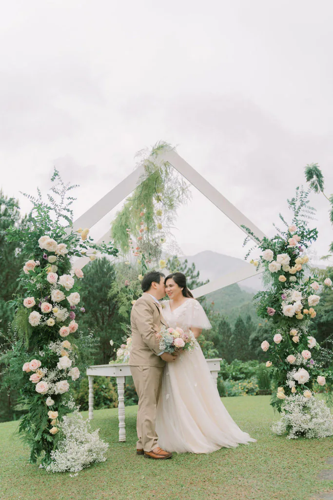 an outdoor 10th wedding anniversary couple Pher and Iah with floral house frame arch by Khim Cruz