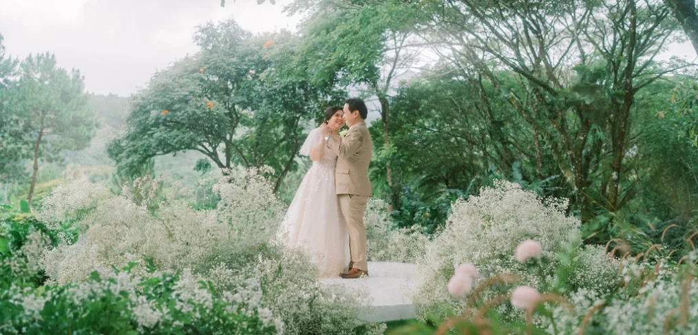 an outdoor 10th wedding anniversary renewal of vows ceremony with Pher and Iah dancing on stage designed by Khim Cruz