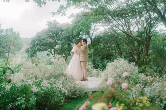 an outdoor 10th wedding anniversary renewal of vows ceremony with Pher and Iah dancing on stage designed by Khim Cruz