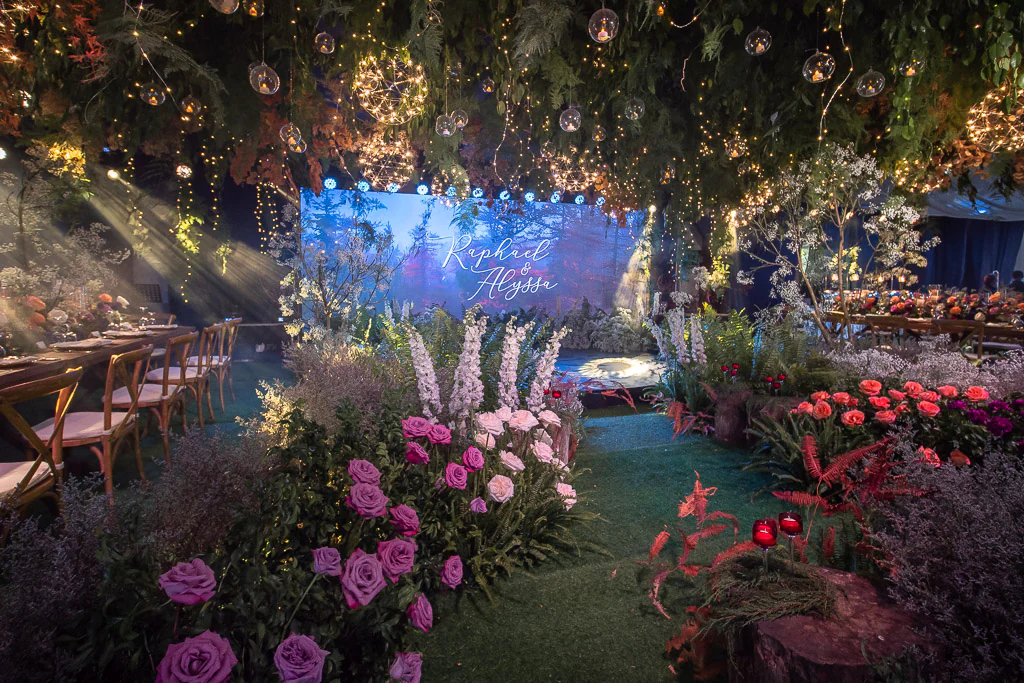 forest-feel wedding for Raphael and Alyssa floral pathway with hanging string lights by Khim Cruz
