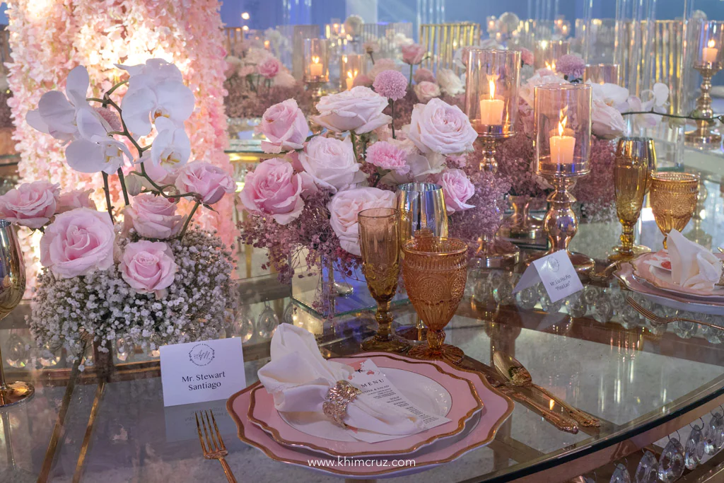 a sophisticated travel themed wedding reception for Anthony and Myka lush floral centerpieces beautifully arranged with cutleries
