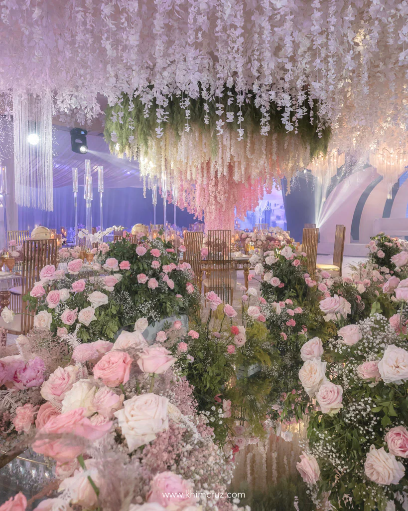a sophisticated travel themed wedding reception for Anthony and Myka with Supertree inspired arragement and floral field pathway designed by florist Khim Cruz