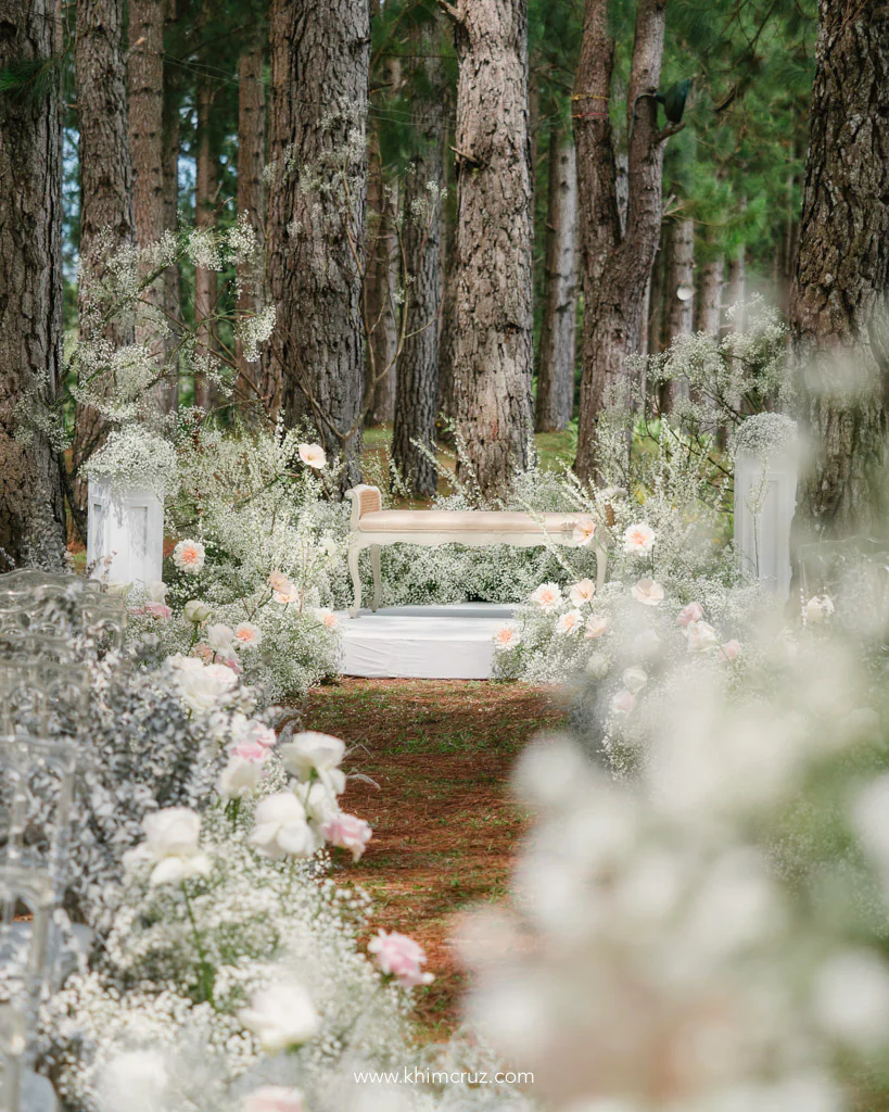forest theme wedding ceremony with couples bench for Christian and Jillian