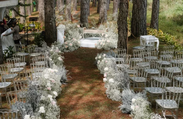 forest themed wedding ceremony twilight feels with pine trees as backdrop and white gypsophilas on aisle pathway by Khim Cruz at scenic Bukidnon