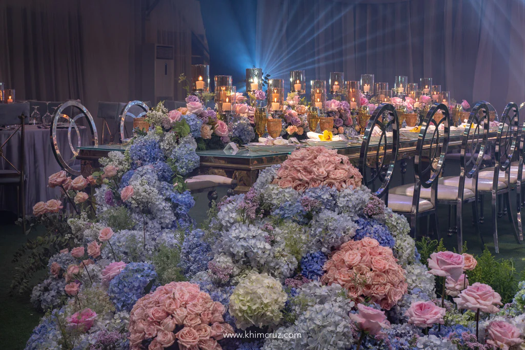 spring wedding reception with cascading hydrangeas and flowers on head table