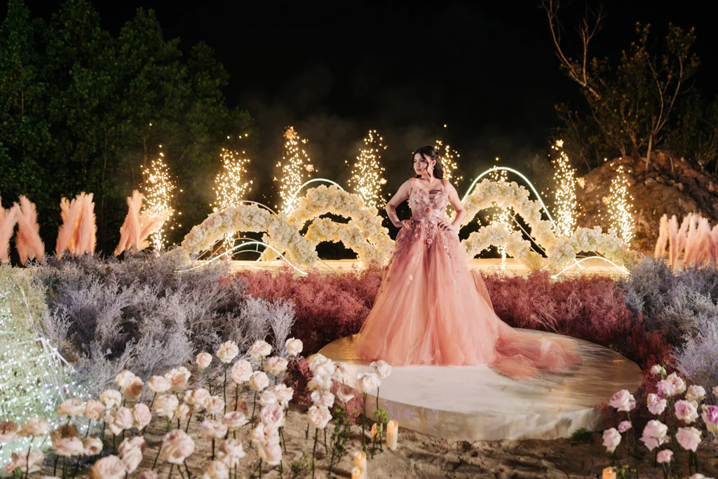 ethereal sophisticated modern debut 18th birthday party of Alesi on floral stage design at night with fireworks on the background