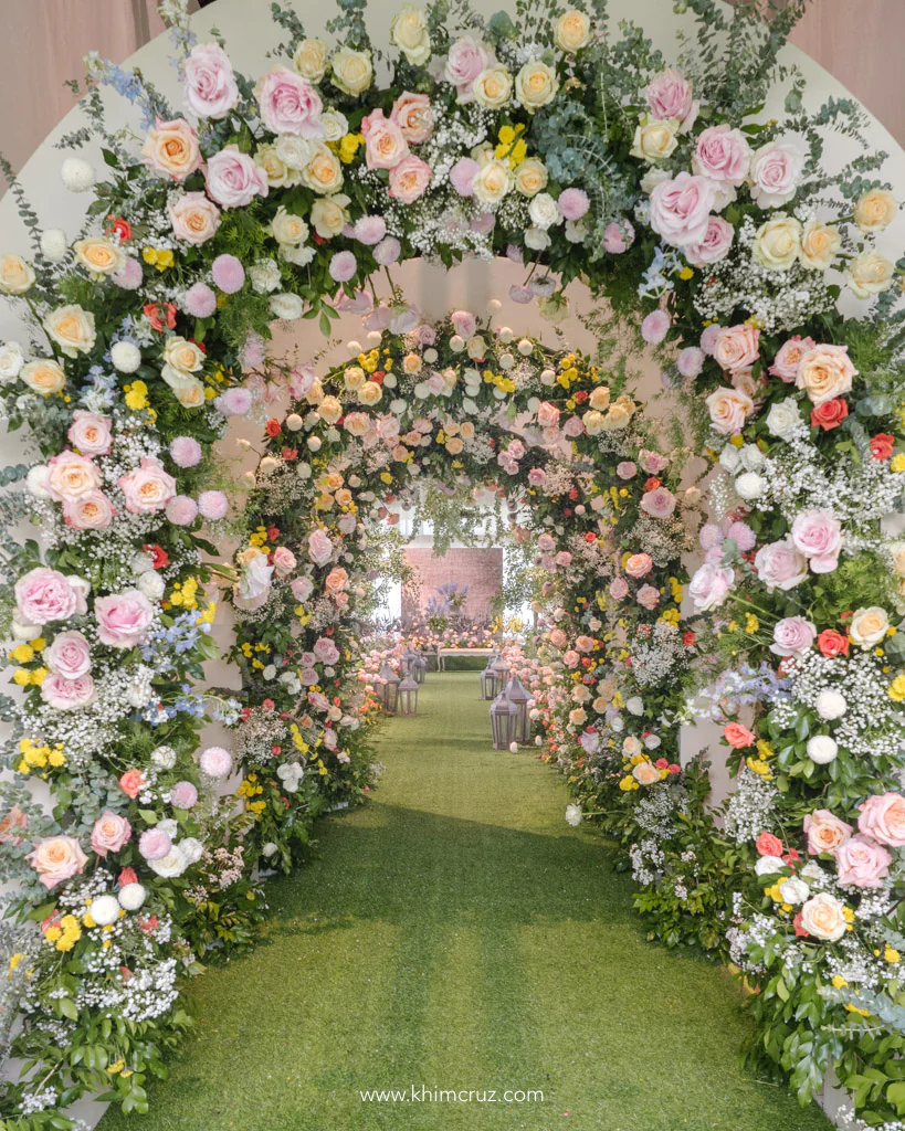 light and fresh-feel Tuscan wedding ceremony floral entrance tunnel arch for Stephen & Valerie designed by Khim Cruz