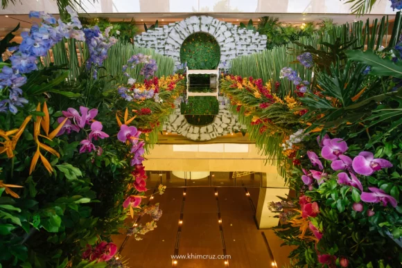 Crazy Rich Asians wedding ceremony aisle florals with stone moon gate as ceremony backdrop