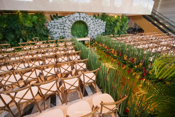 Crazy Rich Asians wedding ceremony overview with aisle florals and stone moon gate as ceremony backdrop