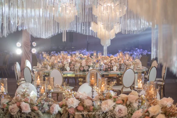 elegant wedding reception of Plong and Glaiza head table enclosing hanging chadeliers above