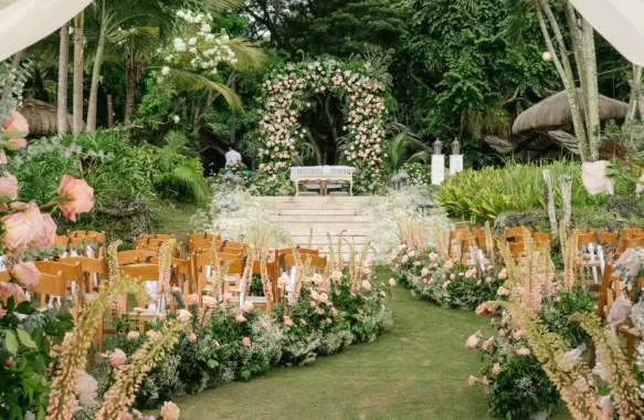 outdoor dreamy wedding ceremony of Uzziel and Patricia with floral pathway and arch by Khim Cruz