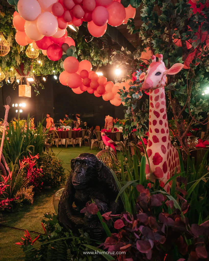 safari expedition themed birthday party entrance pathway with giraffe lion and gorilla