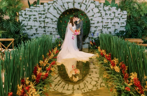 Crazy Rich Asians wedding ceremony with the bride and groom against their ceremony backdrop