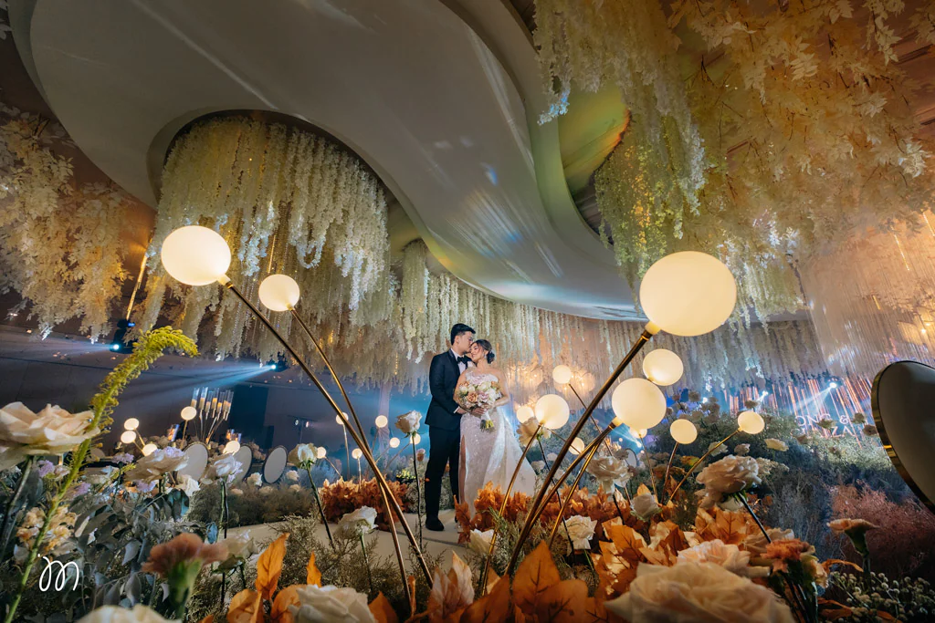 elegant wedding reception of Plong and Glaiza with couple on center stage under the ceiling designed and styled by Khim Cruz