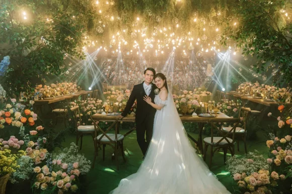 light and fresh-feel Tuscan wedding reception with bride and groom standing in front of the presidential table