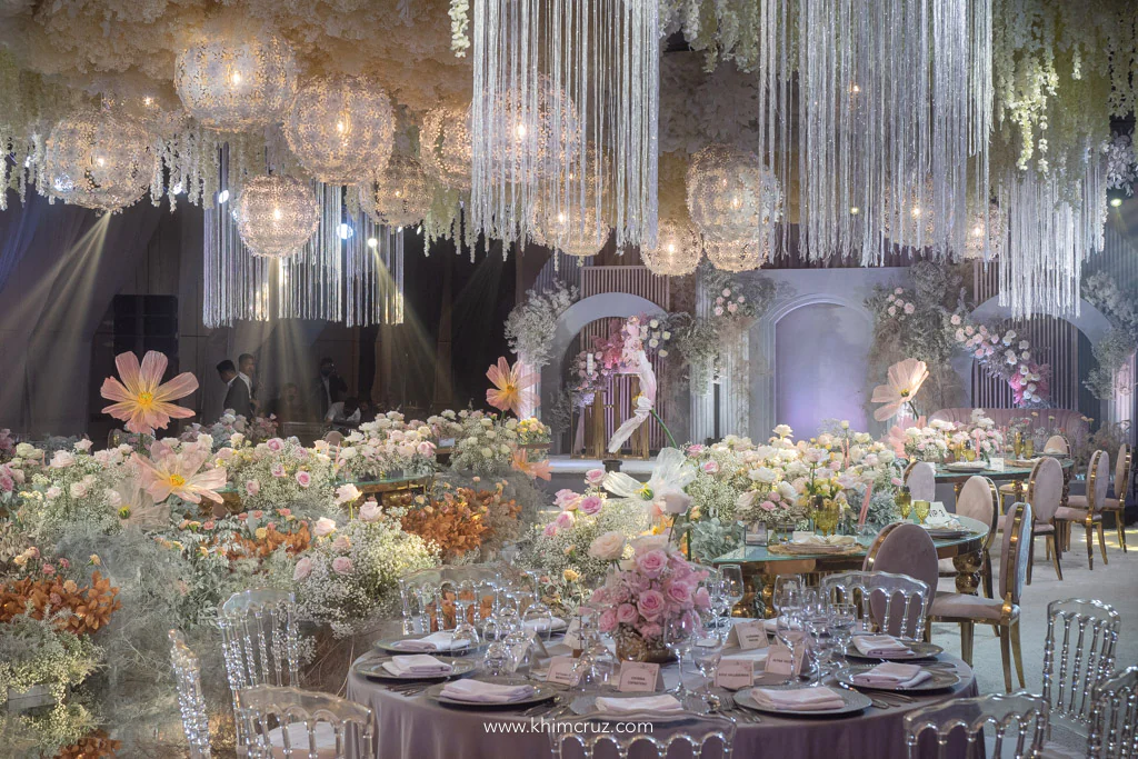 dreamy debut ballroom reception with ceiling works and stage backdrop and floral aisle by Khim Cruz