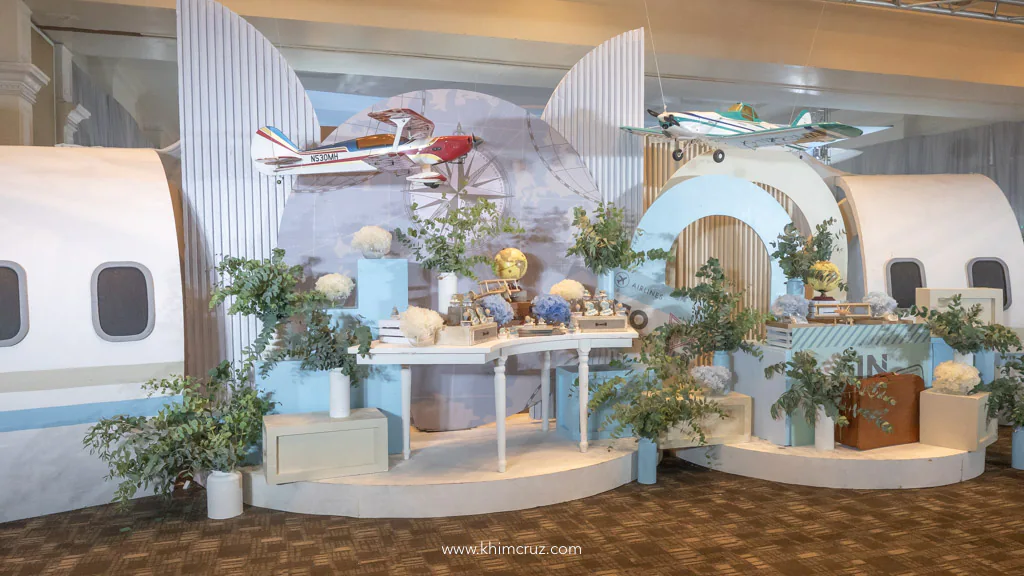 airplane theme birthday party of Alonzzo hanging airplanes over dessert table setup with fuselage backdrop by Khim Cruz