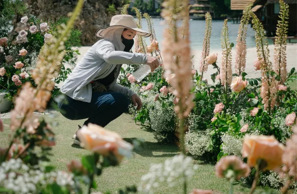 Khim Cruz working on her floral aisle design for a wedding ceremony