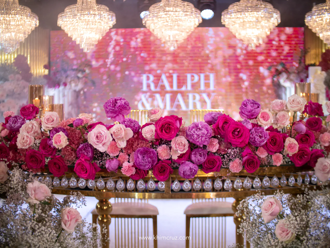 dreamy pink floral hues on the head table arranged by Khim Cruz with chandeliers as the backdrop