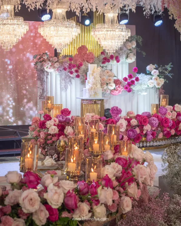 dreamy pink hues floral table centerpieces on a curvy presidential table at the wedding reception of Ralph & Mary arranged by Khim Cruz