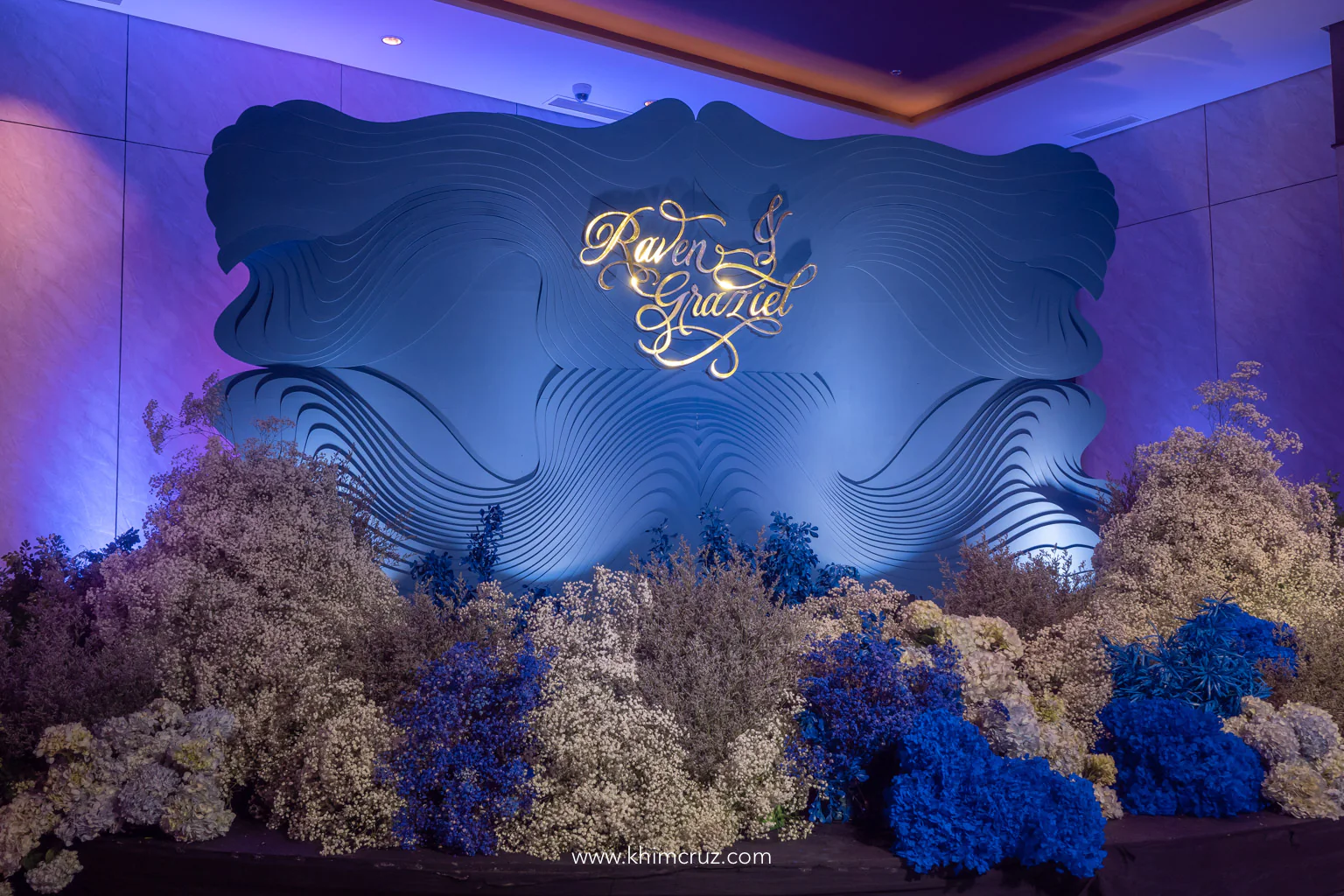 floral photo wall gypsophila and blue flowers at the wedding reception of Raven and Graziel