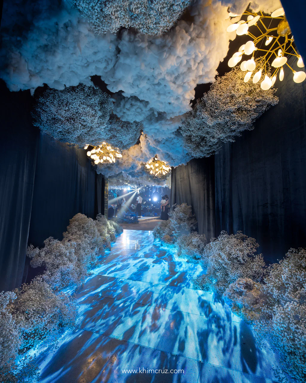 hanging and crawling gypsophila with LED floor panels for the entrance tunnel of a dreamy blue ethereal wedding