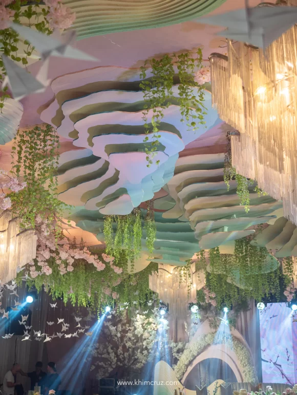 multi-layered mountain installation cascading cherry blossoms and hand-made origami birds ceiling works by Khim Cruz