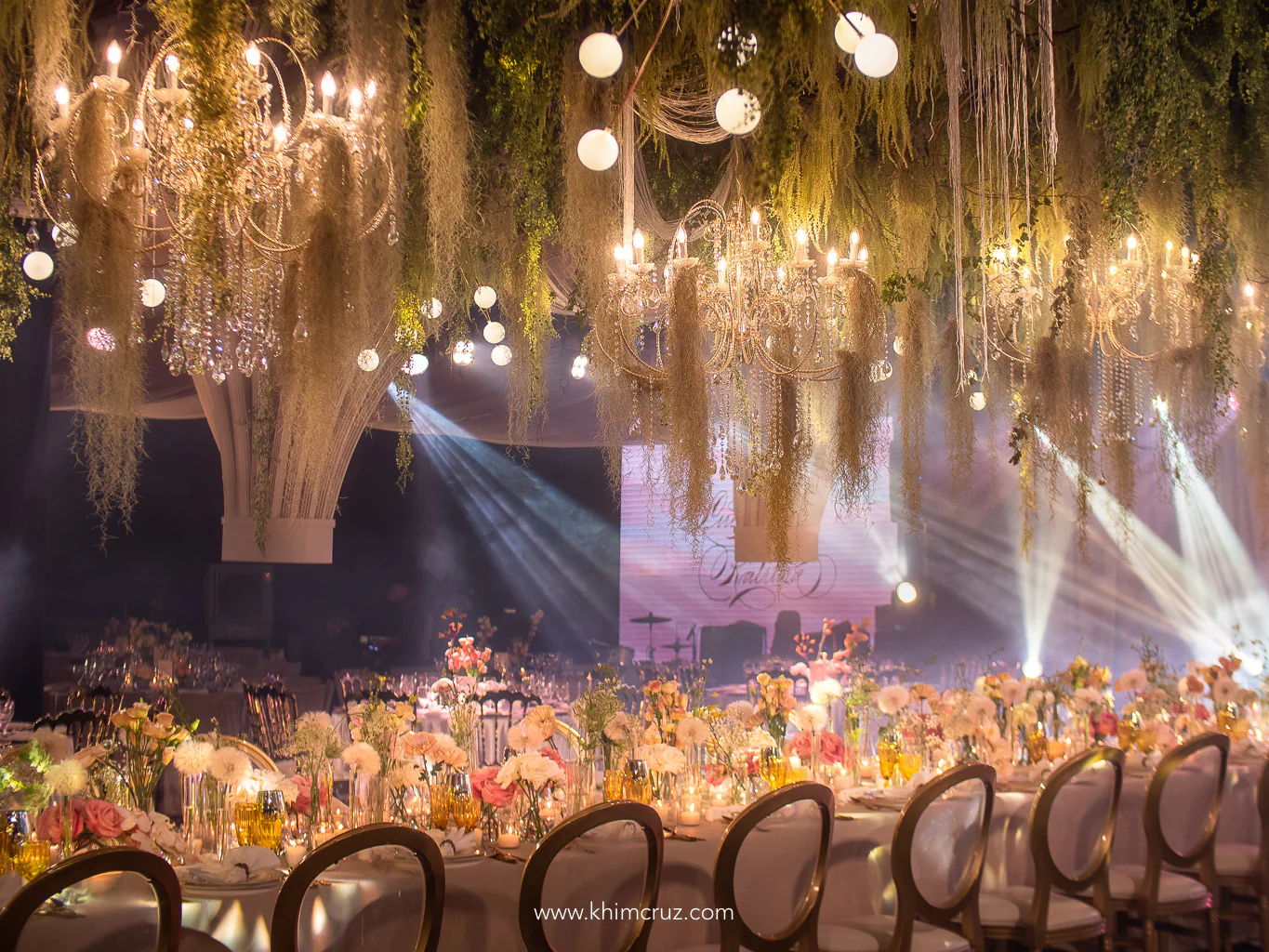 modern old-world hanging chandeliers hanging above presidential table setup by Khim Cruz