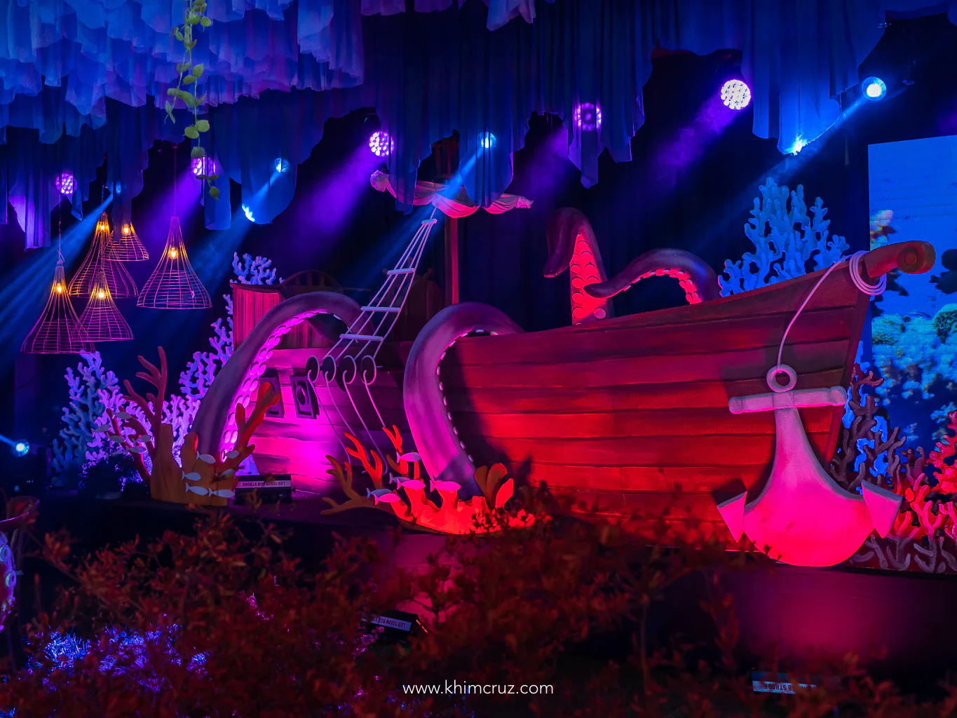 shipwrecked vessel covered by giant squid as stage backdrop of under the sea birthday by Khim Cruz