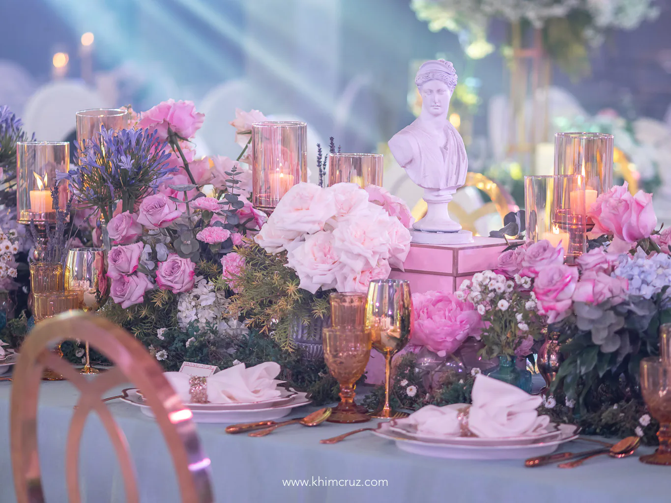 table centerpieces candles and flowers on a chateau gardens themed debut 18th birthday celebration