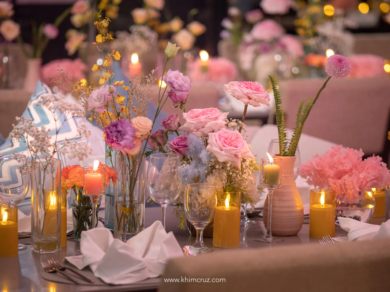 chic soiree flower centerpieces on guest tables roses and candles by Khim Cruz