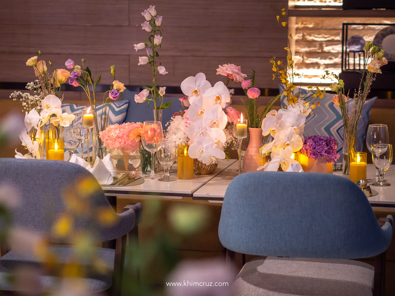 chic soiree guest table floral centerpieces phalaenopsis and candles by Khim Cruz