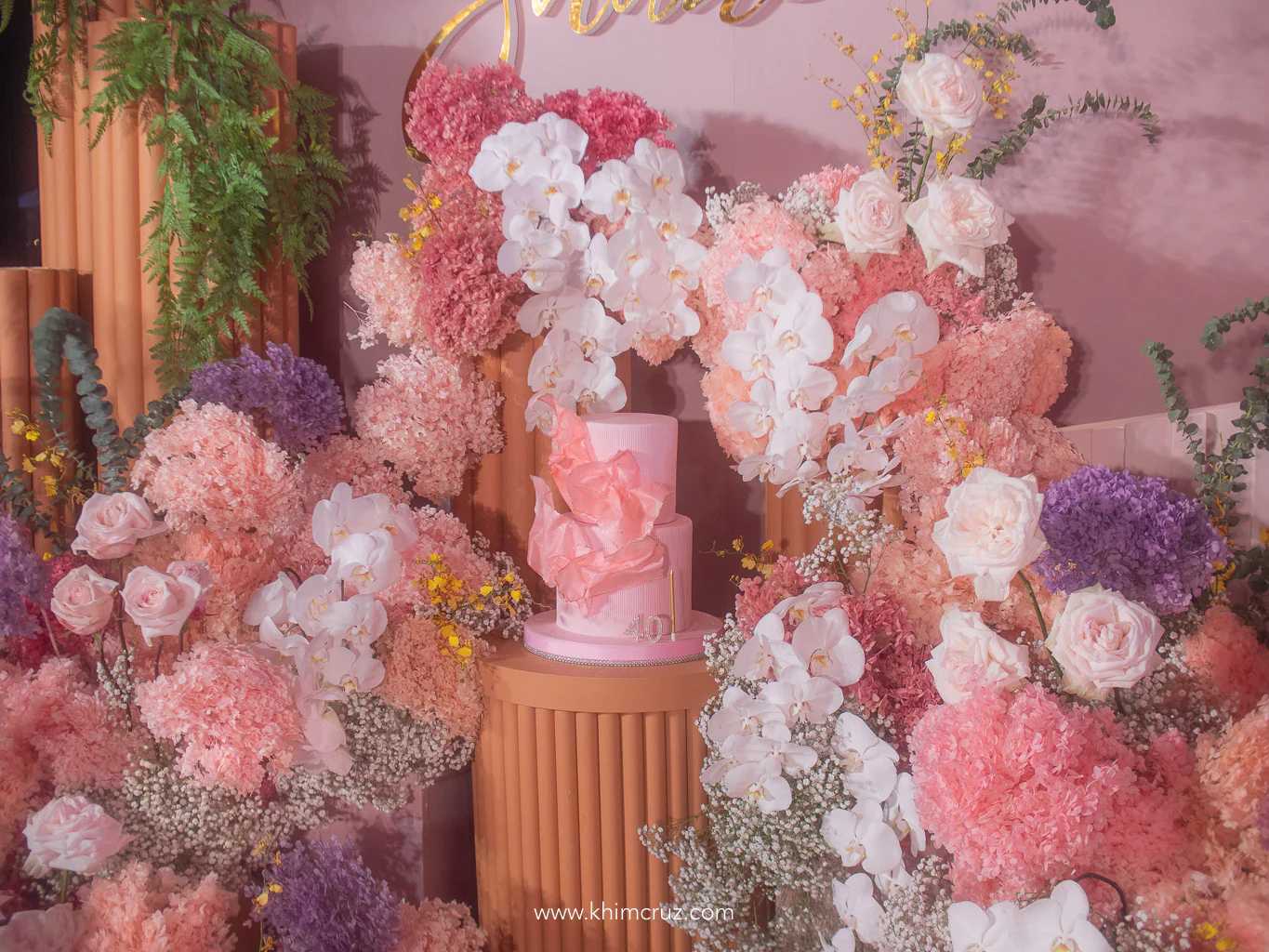 chic soiree pink cake on a beautiful floral backdrop by Khim Cruz