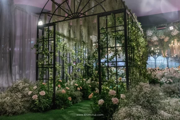 conservatory garden entrance tunnel blending natural hanging air plants and flowers by wedding stylist Khim Cruz