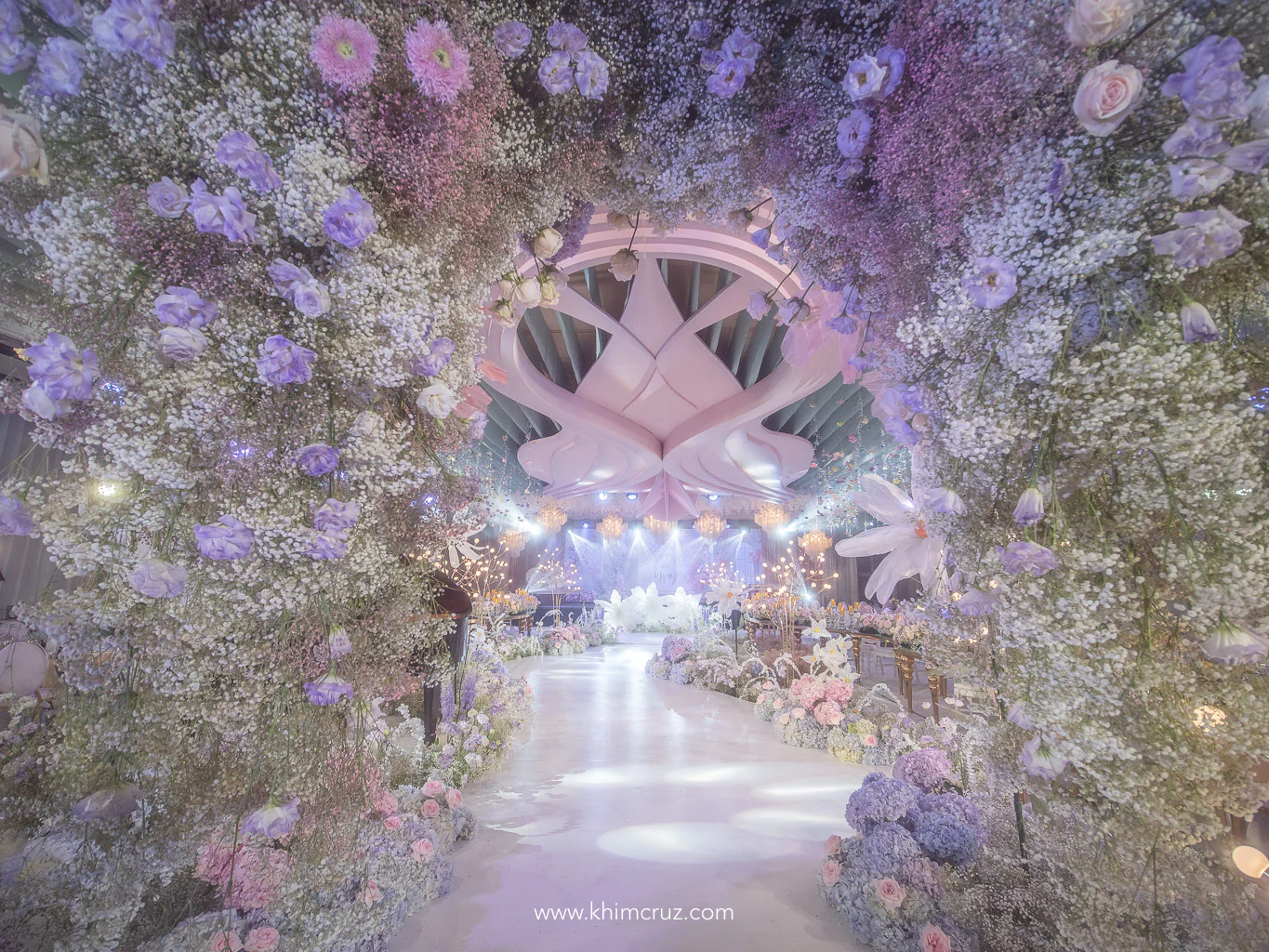 a dreamy floral arch at a garden themed wedding reception by Khim Cruz