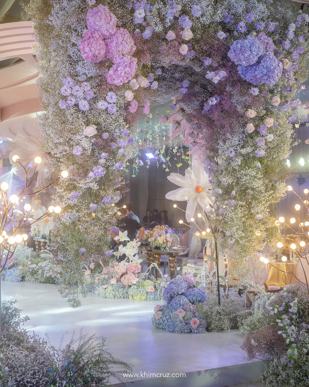 beautiful hanging floral arch at a dreamy floral theme wedding reception by wedding designer Khim Cruz