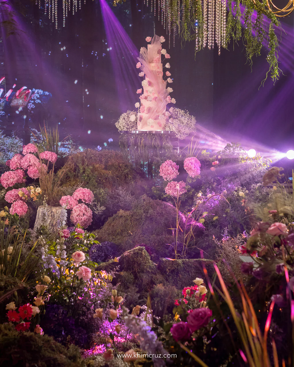 secret enchanted forest ballroom with a meadow of mossy green mounds adorned with accent florals designed by florist Khim Cruz