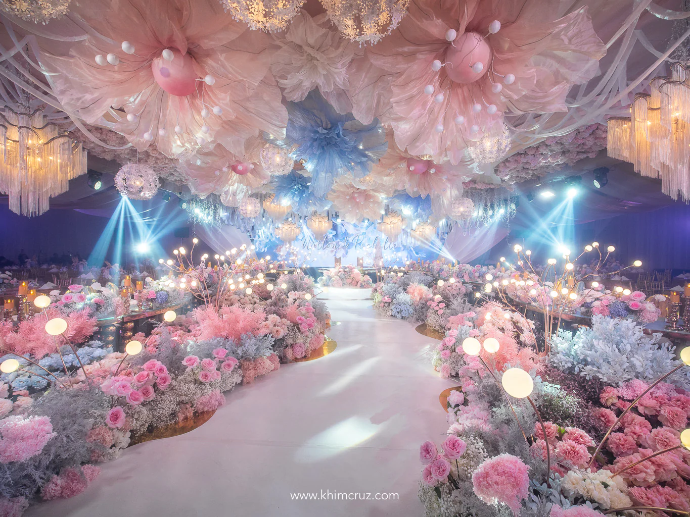 dreamy floral escape wedding hanging oversized floral designs and chandeliers on top of breathtaking floral landscape