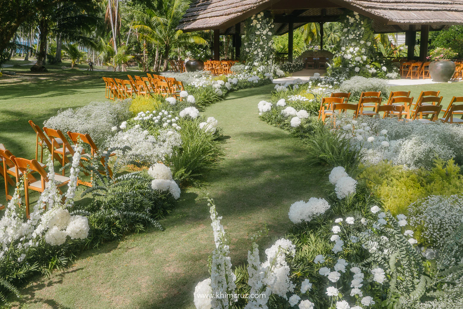 breathtaking flower-filled field island destination wedding ceremony design by Khim Cruz