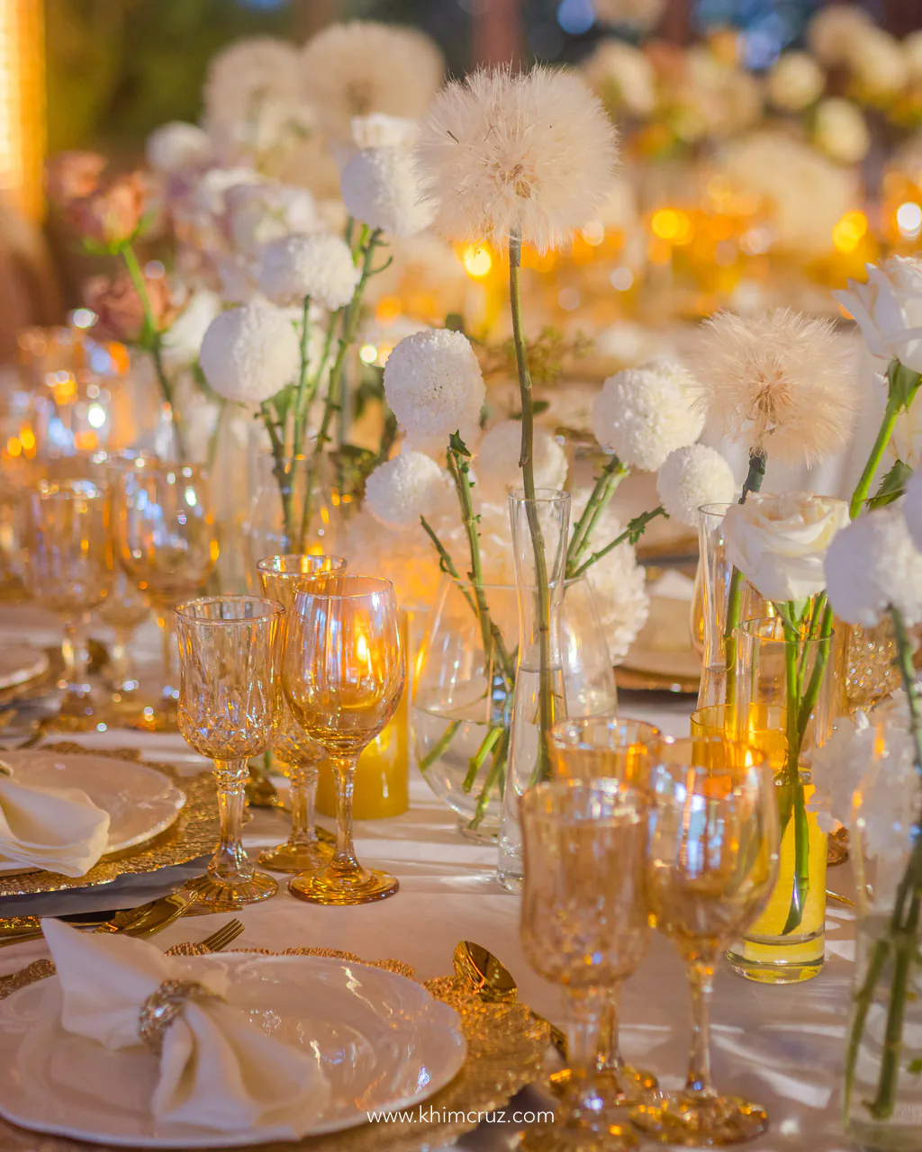 warm glow of candles accompanied beautifully arranged floral centerpieces for wedding reception