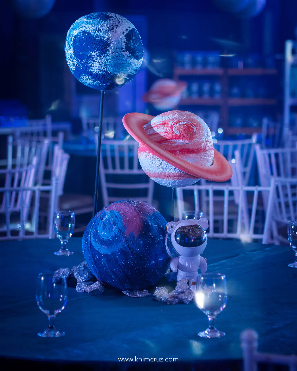 Space-themed birthday table centerpiece featuring astronaut and planets