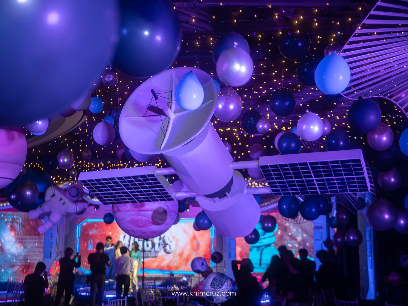 space satellite ceiling installation with planets for a space-themed kid's birthday party