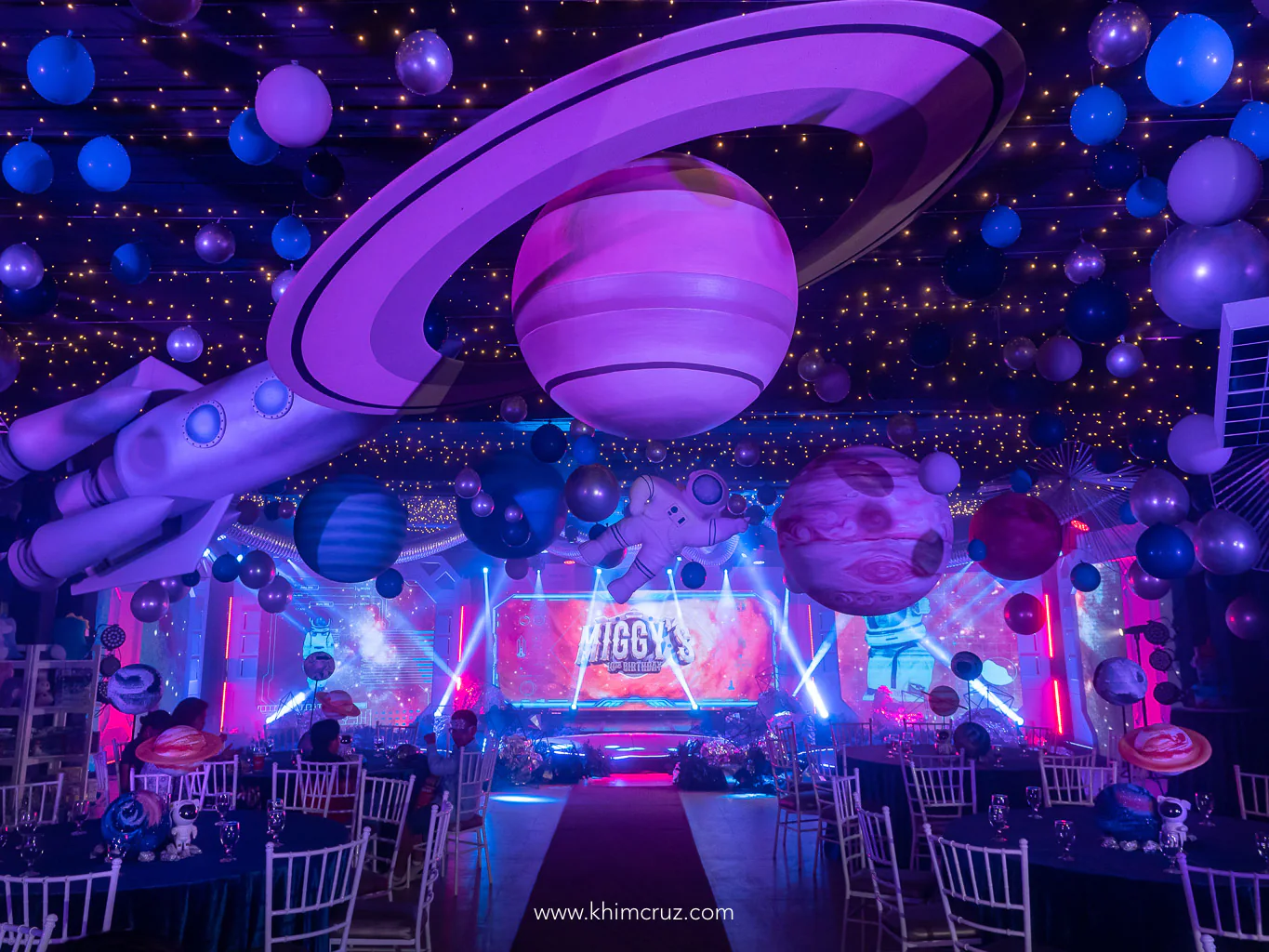 space-themed kid's birthday party with hanging planets and space crafts